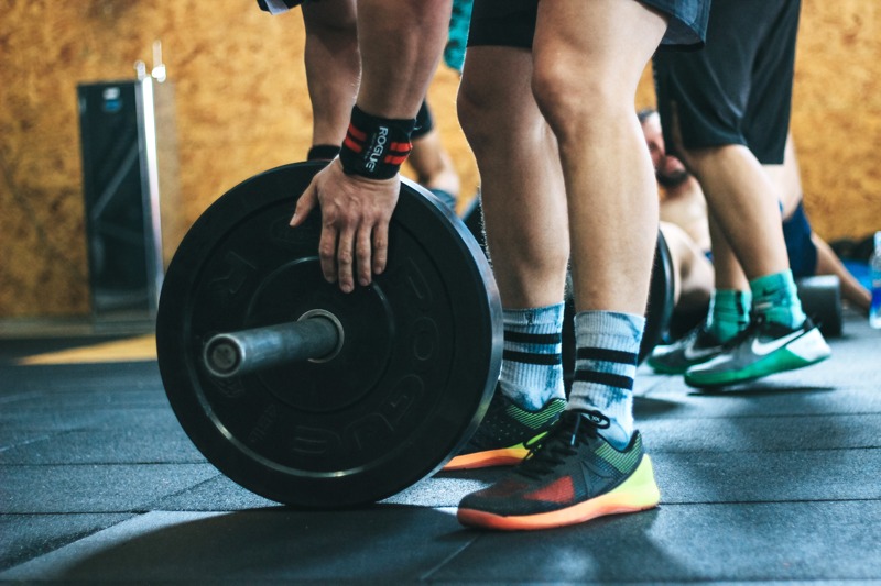 Man adding weights to barbell